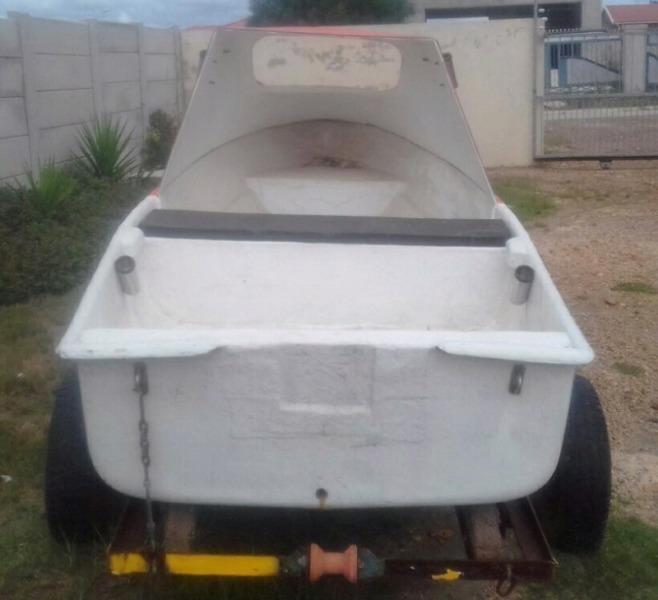 Small cabin boat on trailer with 2.5 Mariner