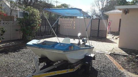 Small fishing boat on licensed trailer, with petrol and electric motor