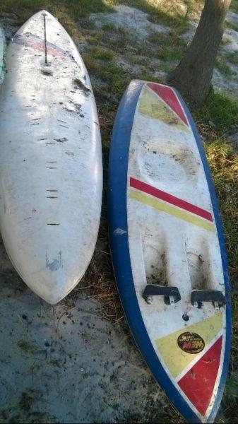 various canoes and knee board and wind surfer for sale