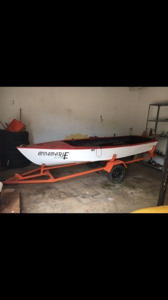 Small boat with electric motor and trailer
