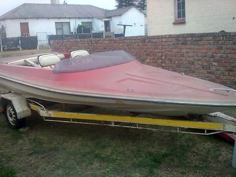 speedboat and trailer with sail