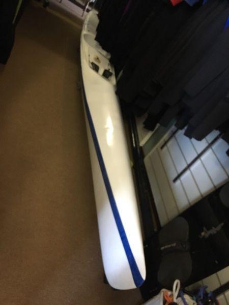 Surfski with adjustable foot pedals