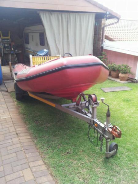 Inflatable rubber boat, motor and trailer